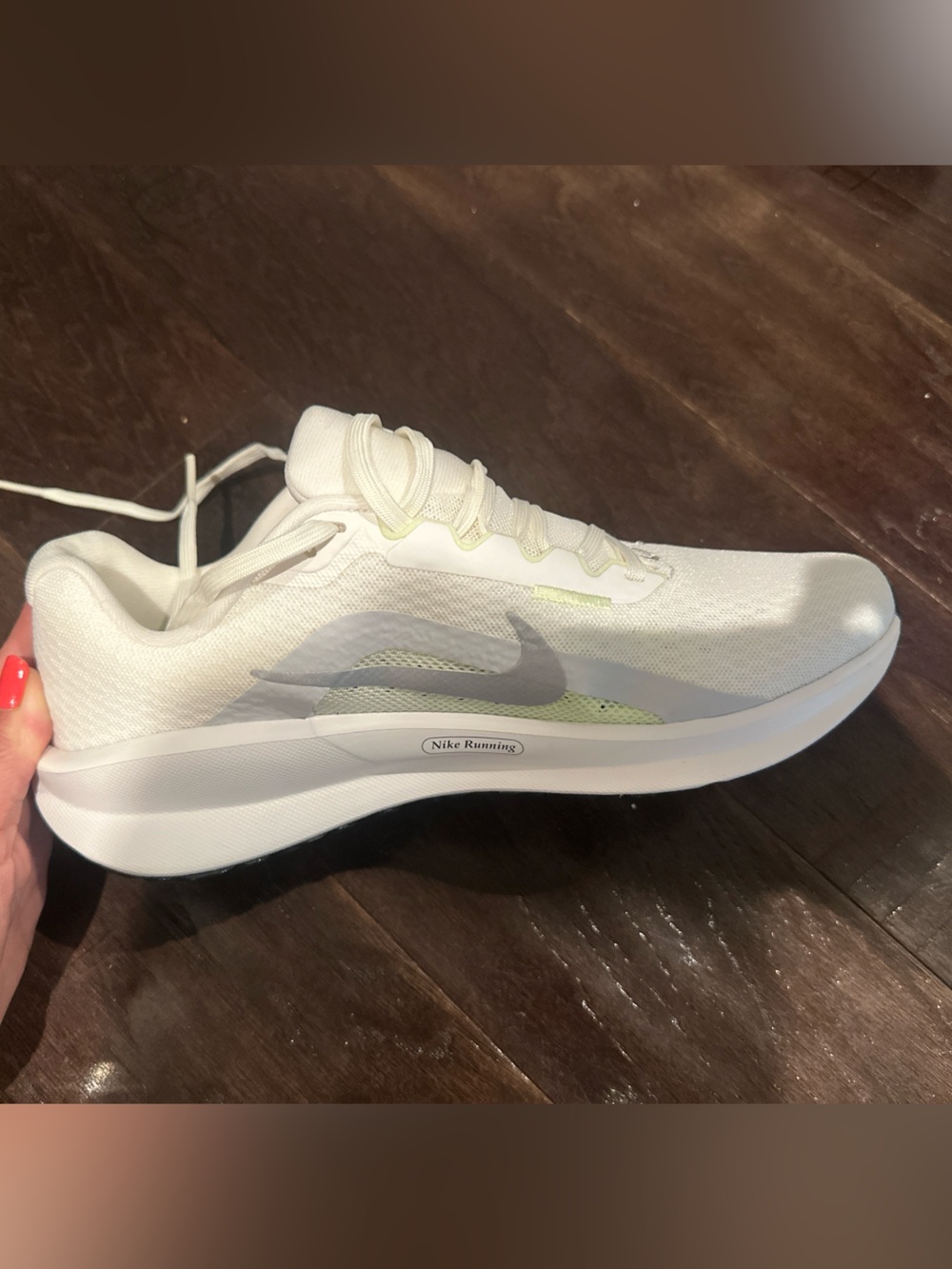 Nike Women's White Running Shoe with Light Gray Swoosh and Pale Yellow Accents